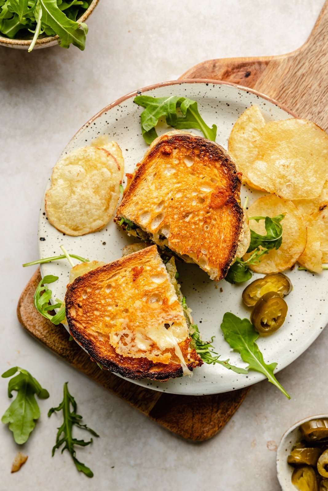 cheese and apple sandwich on a plate with chips