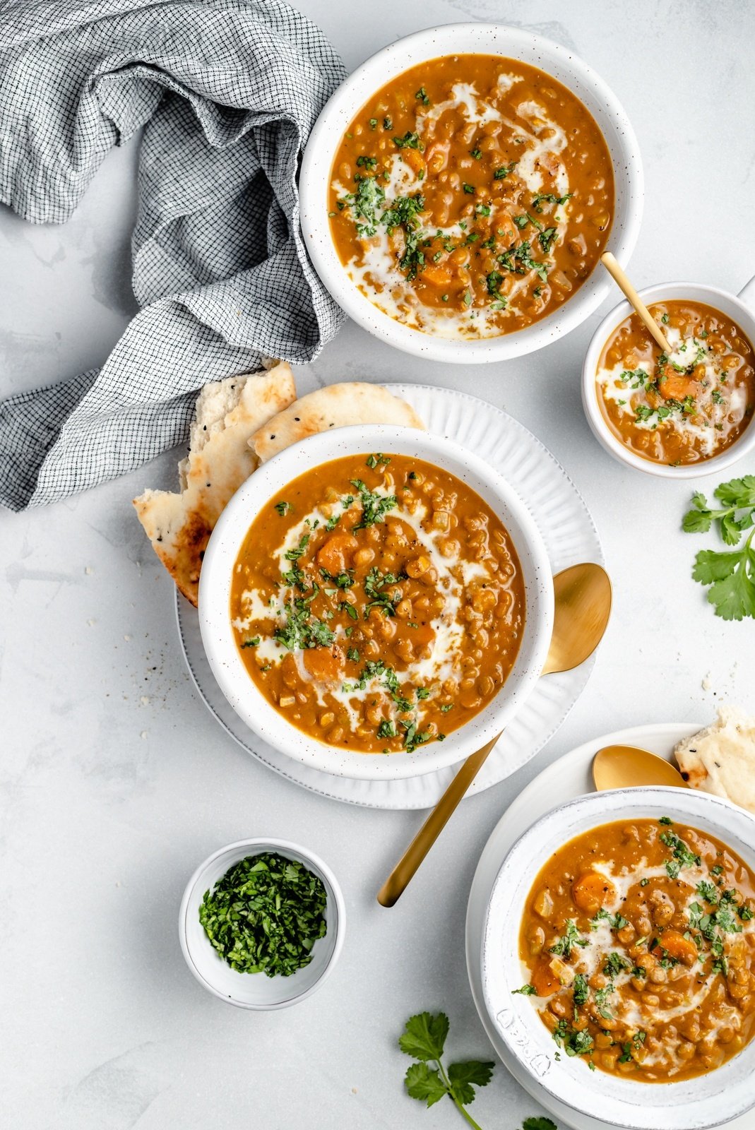 vegan pumpkin lentil soup in four bowls