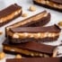 vegan chocolate peanut butter caramel bars on parchment paper