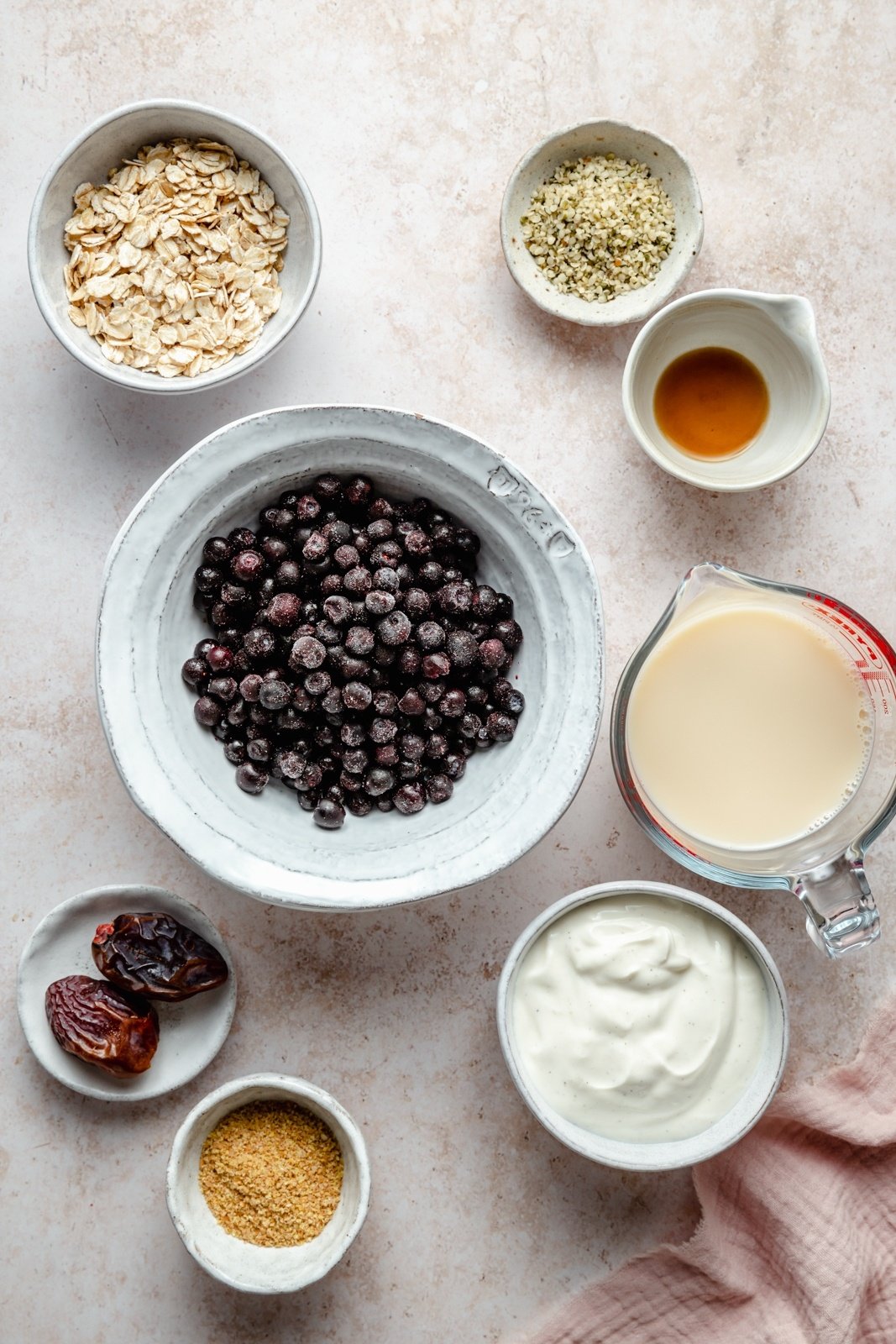 ingredients for a wild blueberry smoothie on a board